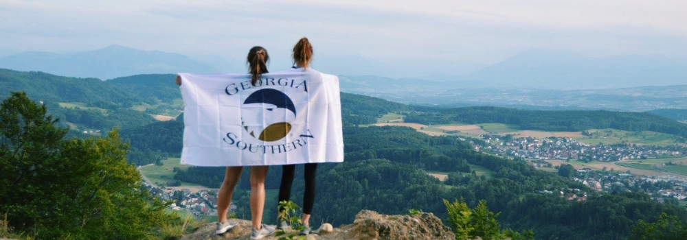 Girls with Flag on Cliff